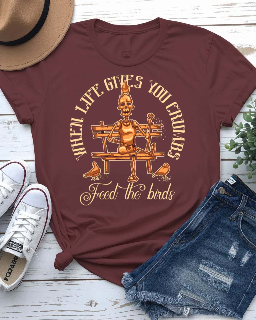 Feed The Bird T-Shirt with hand offering seeds to sparrow on model
