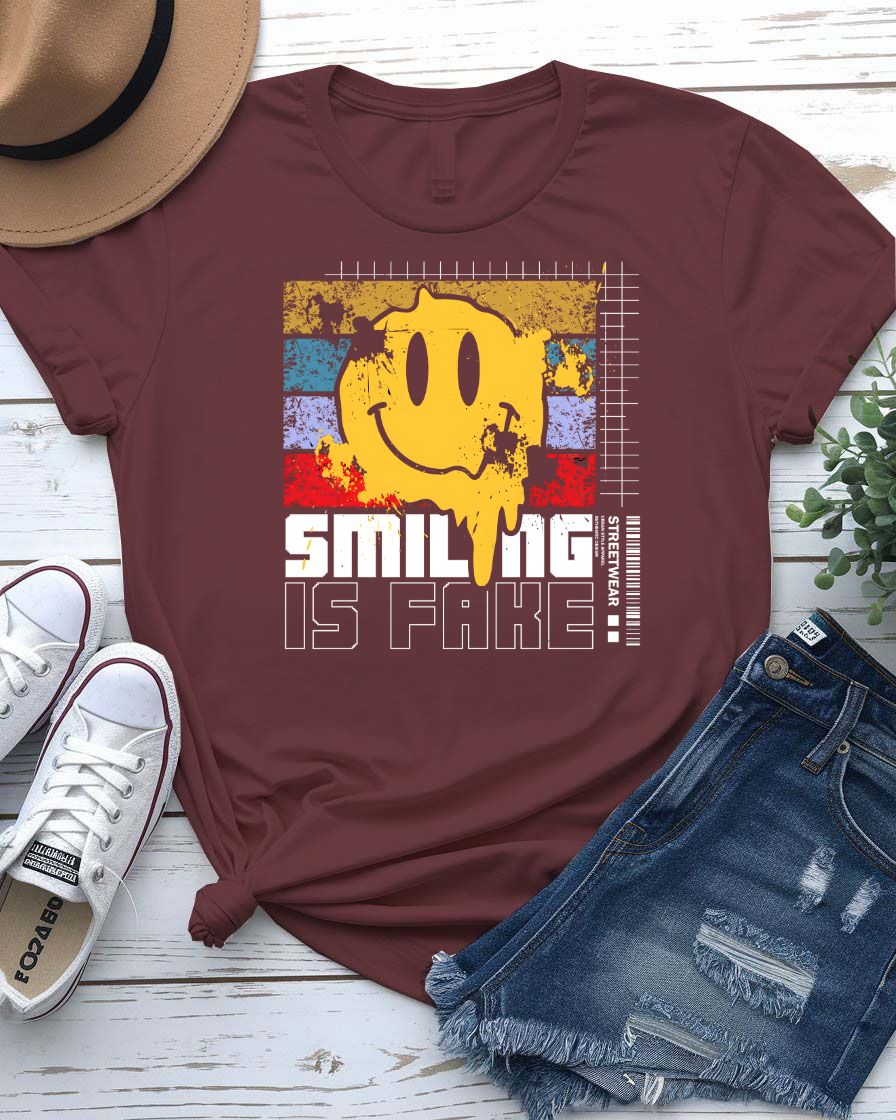 Smiling is Fake urban tee with cracked porcelain smile graphic on model