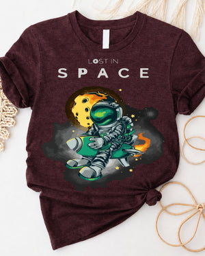 Space graphic t-shirt with astronaut floating through galaxy design front view