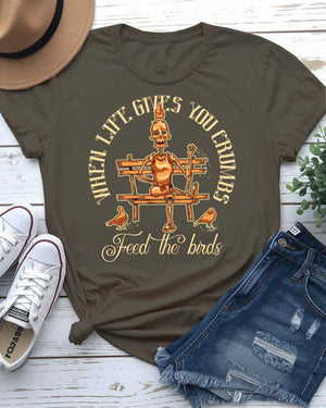 Feed The Bird T-Shirt with hand offering seeds to sparrow on model