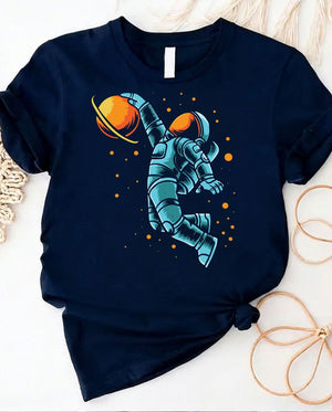 Astronaut playing basketball on moon surface graphic tee