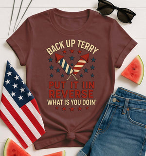 Backup Terry 4th of July Funny Tee by Memez Store – black T-shirt with bold white “Put it in reverse, Terry” meme text and fireworks art.