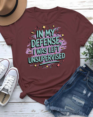 Bold text design meme tee with “In My Defense I Was Left Unsupervised”