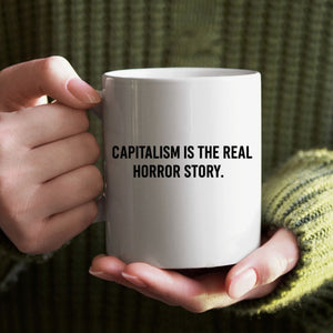 Capitalism Is Real Horror Story mug on office desk