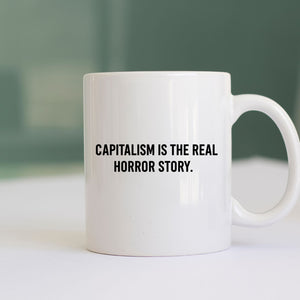 Capitalism Is Real Horror Story mug on office desk