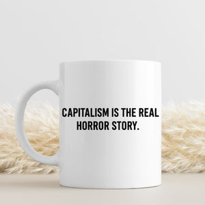 Capitalism Is Real Horror Story mug on office desk