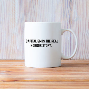 Capitalism Is Real Horror Story mug on office desk