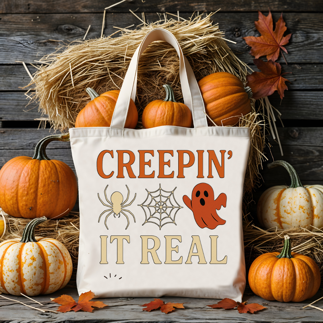 “Creepin’ It Real Halloween tote bag with ghost and spiderweb graphic”