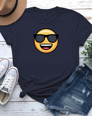 Funny emoji face wearing glasses printed in bold on a unisex t-shirt – shown on smiling model.