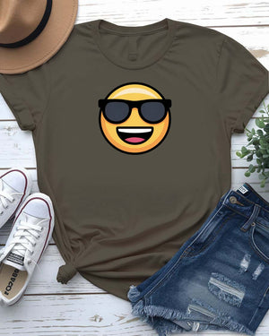 Funny emoji face wearing glasses printed in bold on a unisex t-shirt – shown on smiling model.