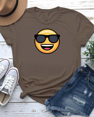 Funny emoji face wearing glasses printed in bold on a unisex t-shirt – shown on smiling model.
