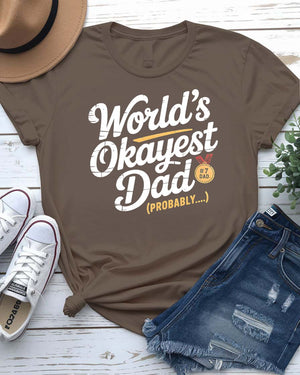 Funny unisex T-shirt featuring the bold typographic phrase “World’s Okayest Dad” in a clean, eye-catching font.
