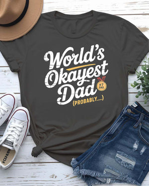 Funny unisex T-shirt featuring the bold typographic phrase “World’s Okayest Dad” in a clean, eye-catching font.