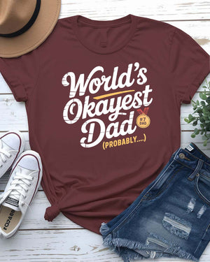 Funny unisex T-shirt featuring the bold typographic phrase “World’s Okayest Dad” in a clean, eye-catching font.
