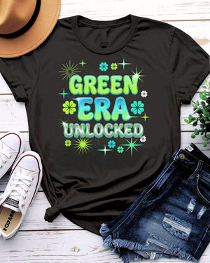Green Era Unlocked St. Patrick's Day Tee with shamrock progress bar on model
