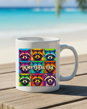 In My Feral Era Raccoon Mug – Funny ceramic coffee cup with chaotic raccoon meme design.