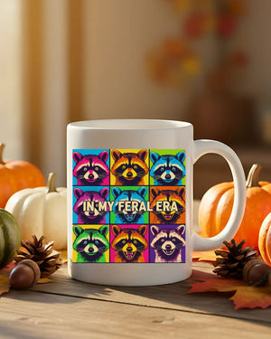 In My Feral Era Raccoon Mug – Funny ceramic coffee cup with chaotic raccoon meme design.