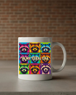 In My Feral Era Raccoon Mug – Funny ceramic coffee cup with chaotic raccoon meme design.