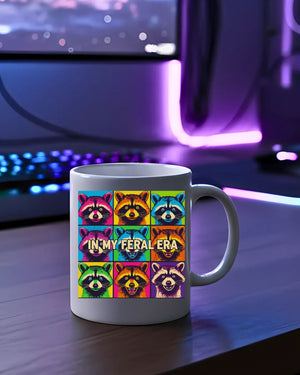 In My Feral Era Raccoon Mug – Funny ceramic coffee cup with chaotic raccoon meme design.