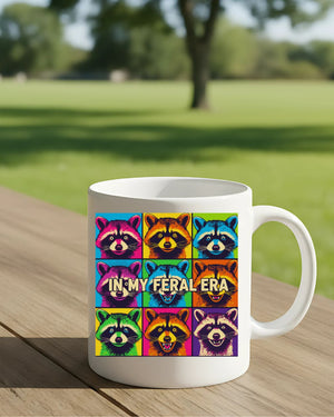 In My Feral Era Raccoon Mug – Funny ceramic coffee cup with chaotic raccoon meme design.