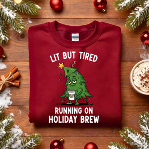 “Lit But Tired Christmas Sweatshirt – funny holiday meme sweatshirt for exhausted coffee lovers, cozy unisex fleece pullover from Memez.Store.