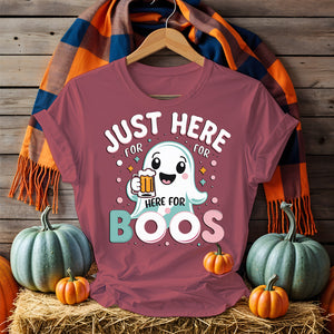Model wearing “Just Here for the Boos” tee holding a drink at a Halloween party