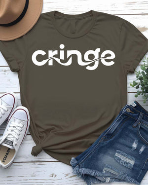 Model wearing the “Cringe” typographical t-shirt in black, smiling awkwardly, styled with denim and sneakers against a neutral background