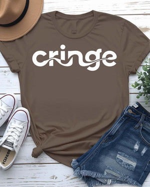 Model wearing the “Cringe” typographical t-shirt in black, smiling awkwardly, styled with denim and sneakers against a neutral background