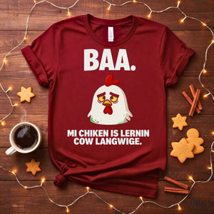 “My Chicken Is Learning Language Meme Funny Tee featuring a talking chicken wearing glasses and holding a book — funny unisex meme shirt.”