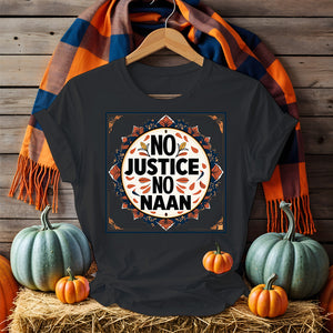 “No Justice No Naan” printed on tee flatlay with naan bread and curry in background