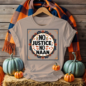 “No Justice No Naan” printed on tee flatlay with naan bread and curry in background