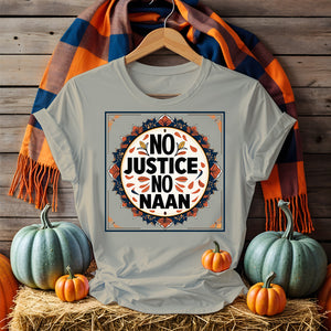 “No Justice No Naan” printed on tee flatlay with naan bread and curry in background