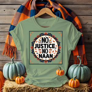 “No Justice No Naan” printed on tee flatlay with naan bread and curry in background