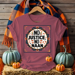 “No Justice No Naan” printed on tee flatlay with naan bread and curry in background