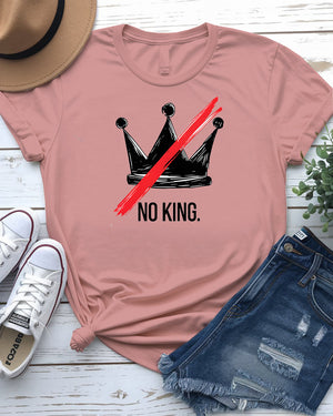 “No King” political meme t-shirt in black with white bold text, displayed on unisex model in urban setting – Memez Store