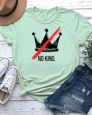 “No King” political meme t-shirt in black with white bold text, displayed on unisex model in urban setting – Memez Store