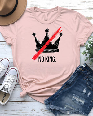 “No King” political meme t-shirt in black with white bold text, displayed on unisex model in urban setting – Memez Store