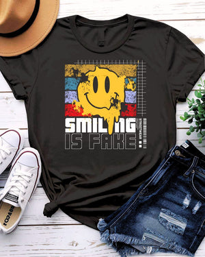 Smiling is Fake urban tee with cracked porcelain smile graphic on model