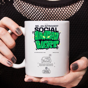 Introvert meme coffee mug close-up on desk