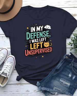 Unisex T-shirt with “In My Defense I Was Left Unsupervised” text in bold white distressed typography – worn by male and female models, casual setting.