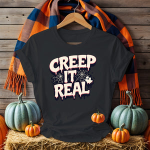 Unisex funny Halloween T-shirt with ghost and pumpkin meme art, laid flat with spooky decor 