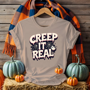 Unisex funny Halloween T-shirt with ghost and pumpkin meme art, laid flat with spooky decor 