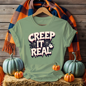 Unisex funny Halloween T-shirt with ghost and pumpkin meme art, laid flat with spooky decor 