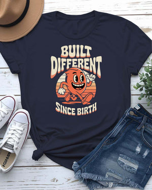 Unisex meme shirt with bold “Built Different Since Birth” typography, styled in casual streetwear.