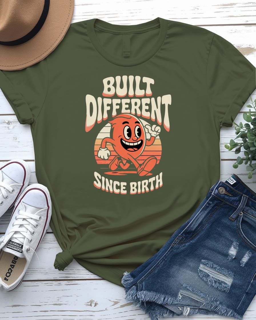 Unisex meme shirt with bold “Built Different Since Birth” typography, styled in casual streetwear.