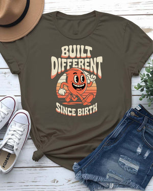 Unisex meme shirt with bold “Built Different Since Birth” typography, styled in casual streetwear.