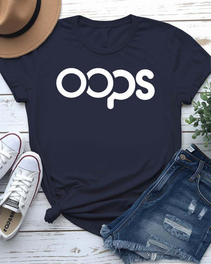 Unisex model wearing a white “Oops” typographical meme tee, styled casually with jeans, laughing and looking off-camera
