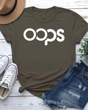 Unisex model wearing a white “Oops” typographical meme tee, styled casually with jeans, laughing and looking off-camera