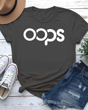 Unisex model wearing a white “Oops” typographical meme tee, styled casually with jeans, laughing and looking off-camera