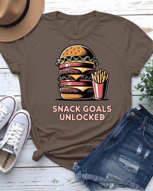 Unisex t-shirt with “Snack Goals Unlocked” text in gamer-style design by Memez Store